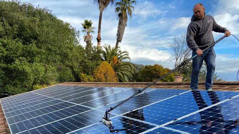 Solar panel cleaning using pure water fed system on a roof